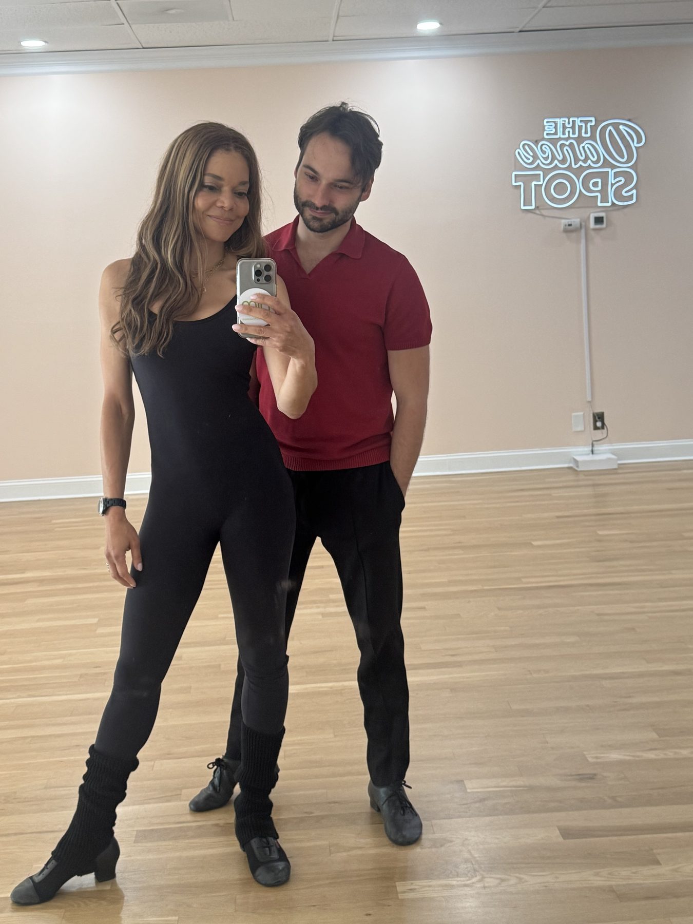 Nikki Jones and her dance partner in a mirror photo at The Dance Spot studio